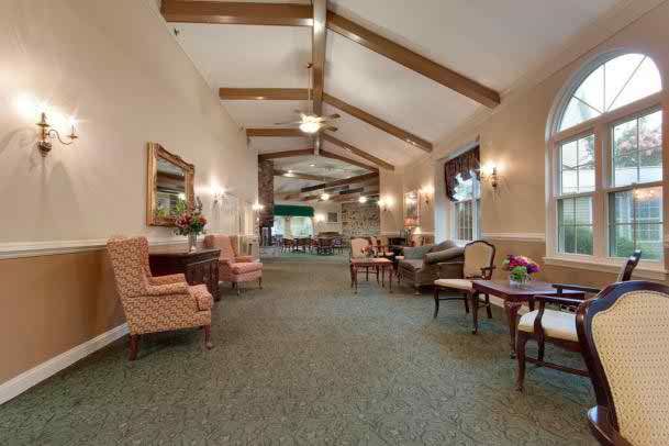 Spacious lobby with comfortable seating and decorative ceiling beams.