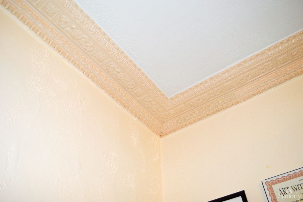 A room corner featuring crown molding at the ceiling.