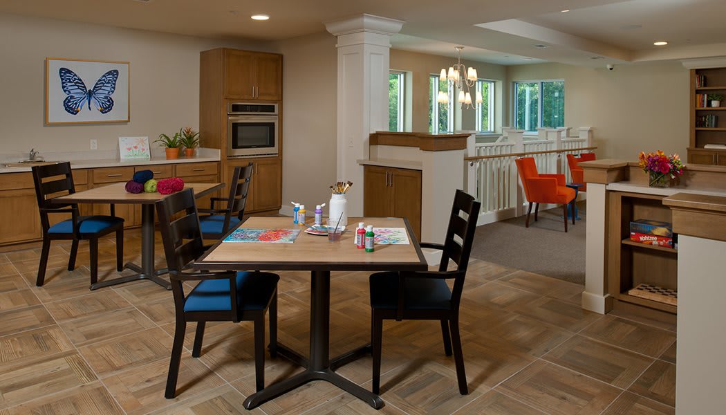 A modern dining area with a table and chairs in an open kitchen space.