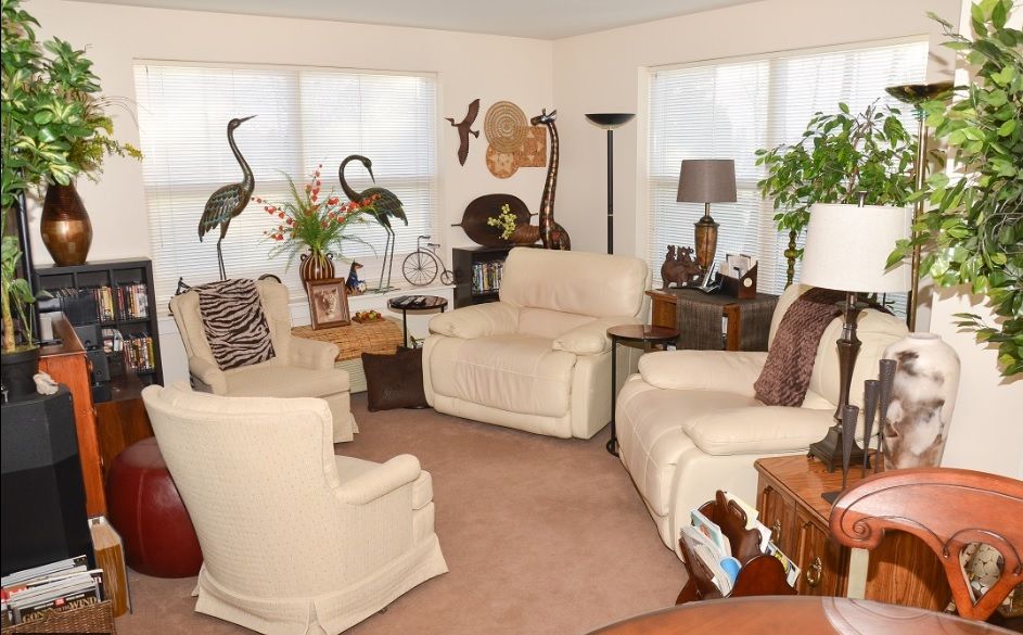 A cozy living room with plush chairs, elegant decor, and soft neutral tones.