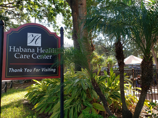 A welcoming sign for the Habana Healthcare Center, surrounded by lush greenery.