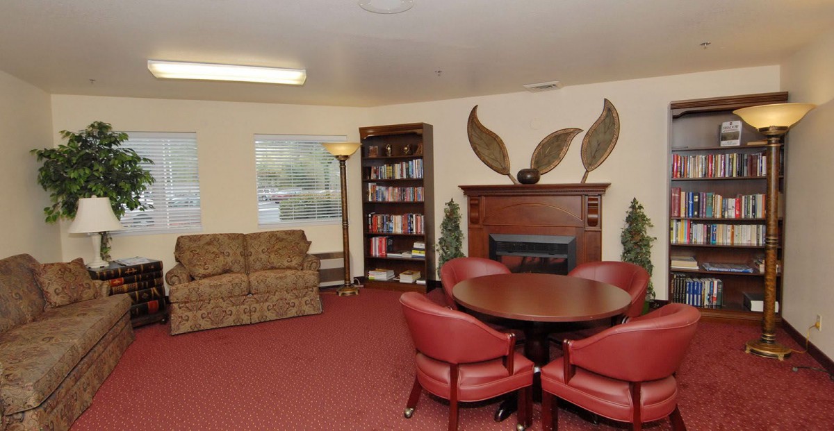 Cozy living room with a fireplace, sofa, and a seating area.