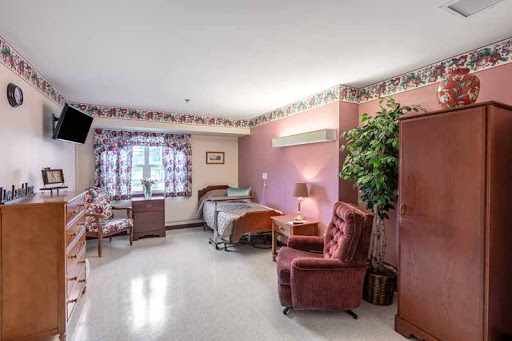 A cozy hospital room featuring comfortable seating and a well-lit ambiance.