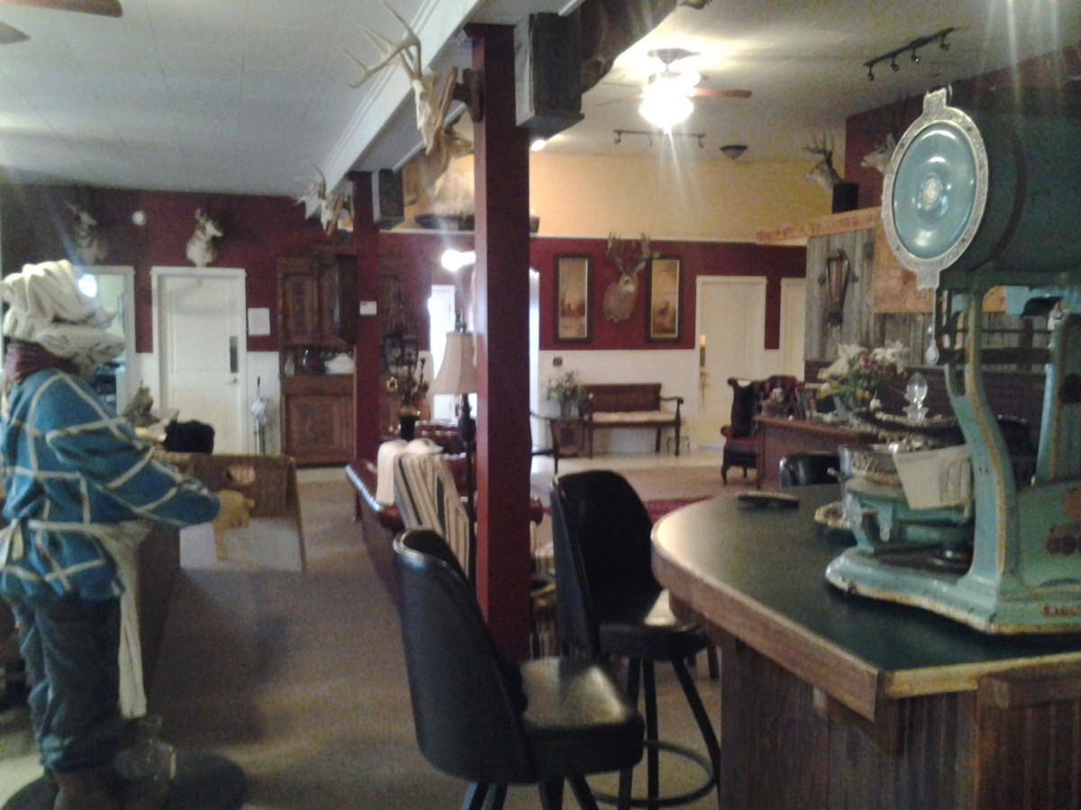 A cozy bar interior with seating and rustic decor.