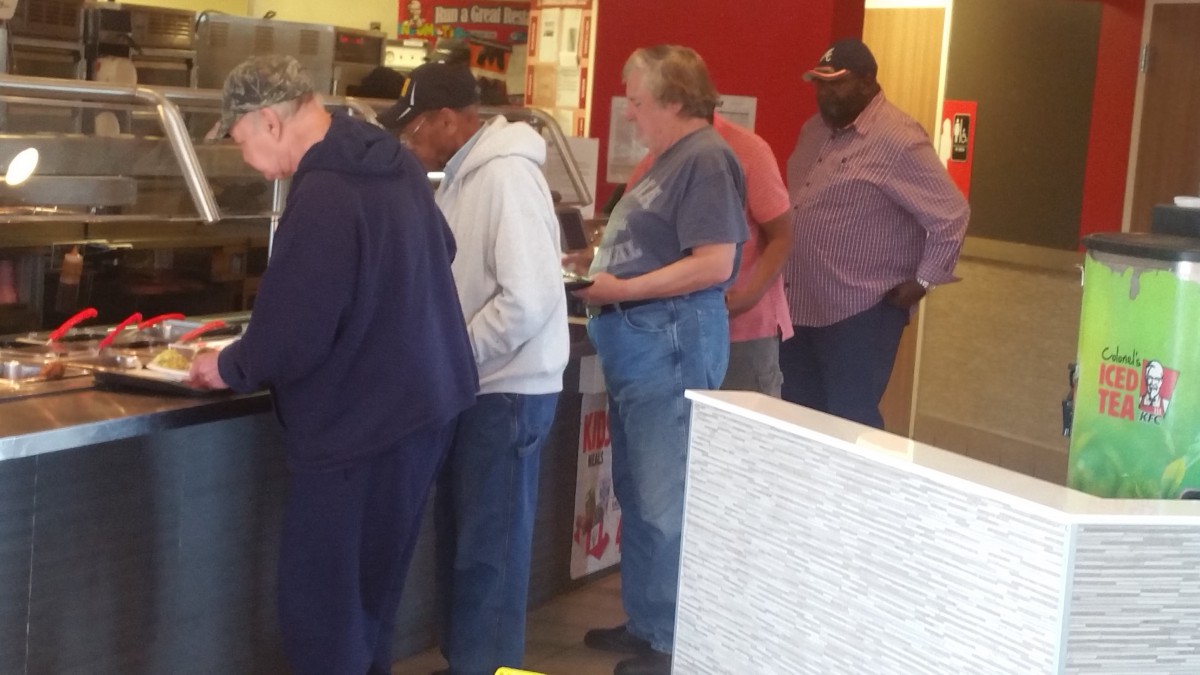 A group of people standing in line inside a store.