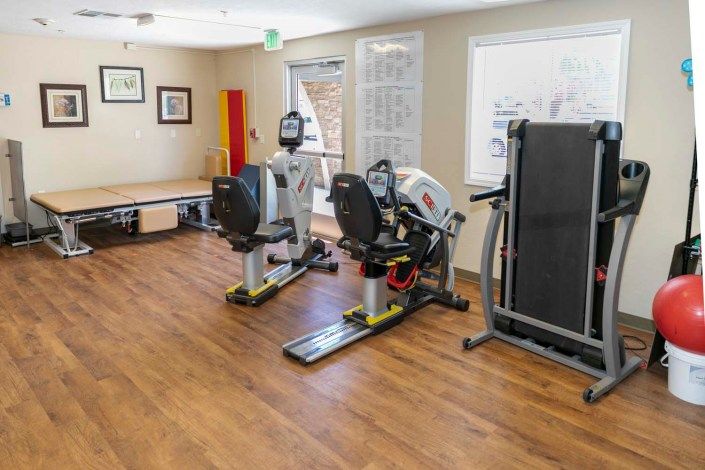 A well-equipped indoor gym with exercise machines.