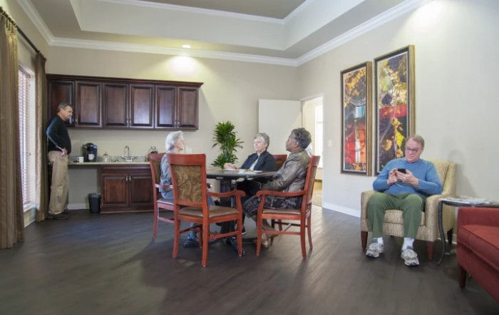 A group of seniors socializing in a cozy living room setting.