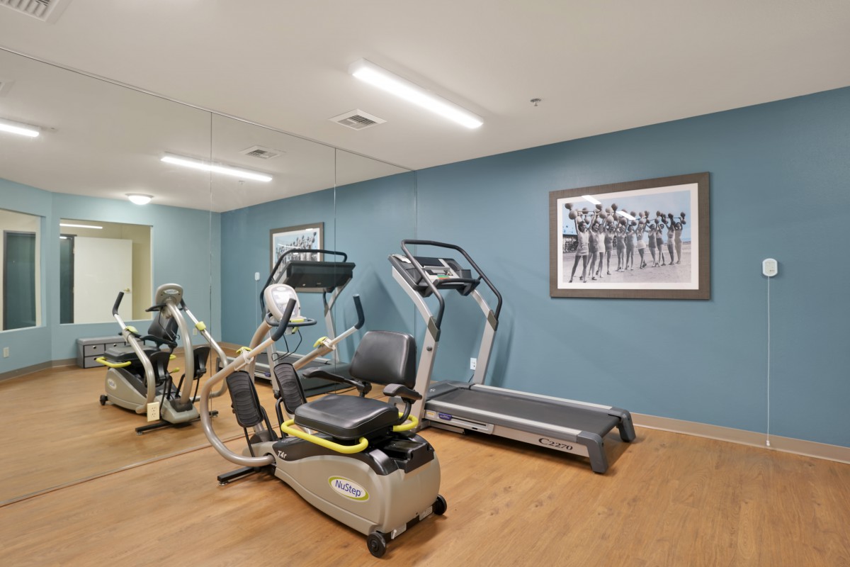 A modern gym with exercise equipment including a treadmill.