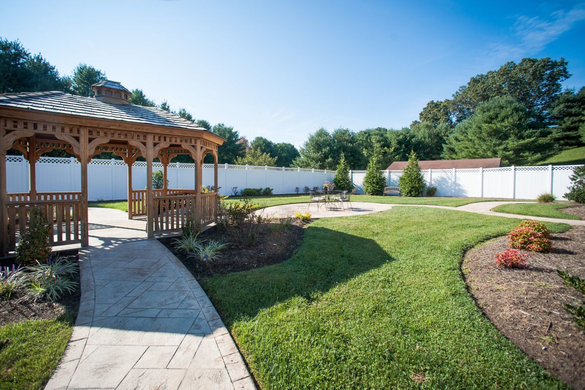 A beautifully landscaped garden with a gazebo and well-maintained lawn.