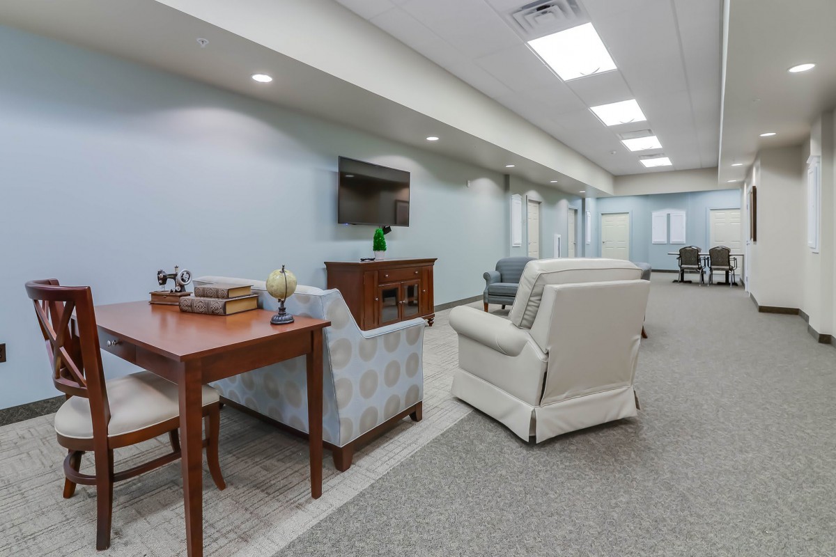 A modern living room with comfortable seating arrangements and a television.