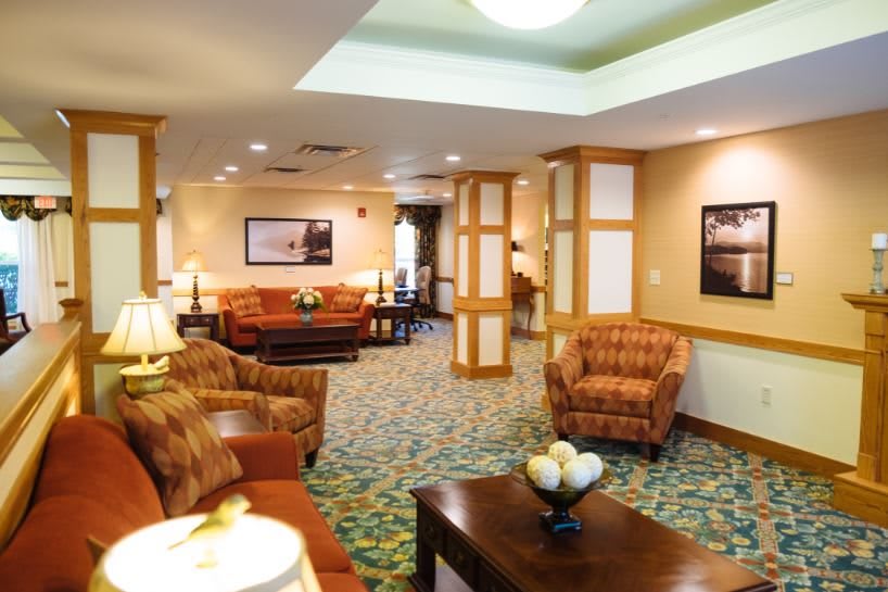 A cozy and well-furnished living room with comfortable seating and warm lighting.