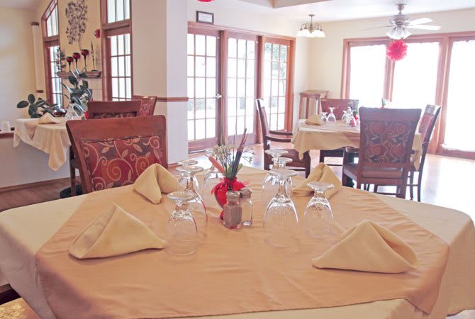 A well-set dining table in a cozy restaurant interior.