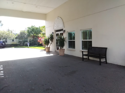 A welcoming entrance with outdoor seating and lush greenery.