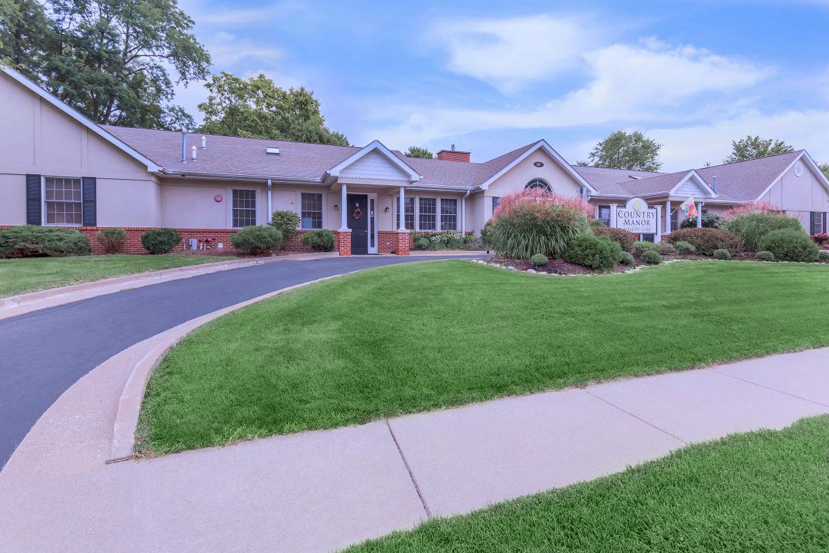 A suburban house with a well-maintained lawn and driveway.