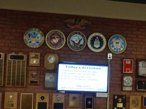 A display of military emblems and a presentation screen outlining today's activities.