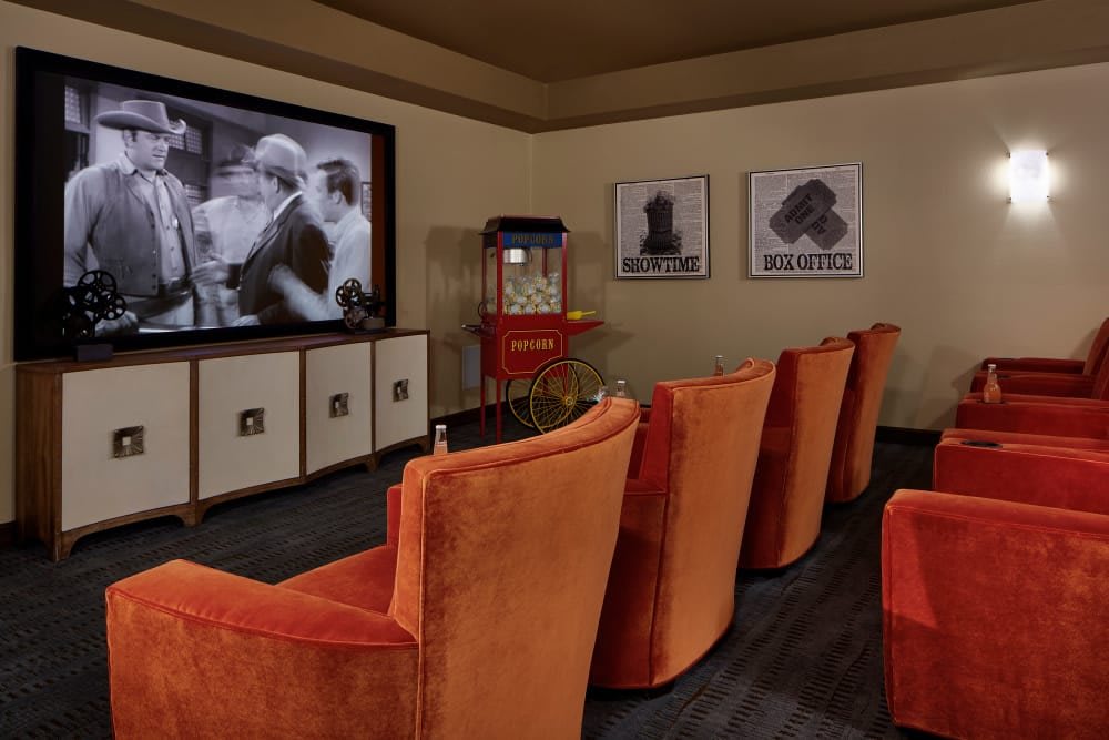 A cozy home theater setup with vintage-style dcor and plush seating.