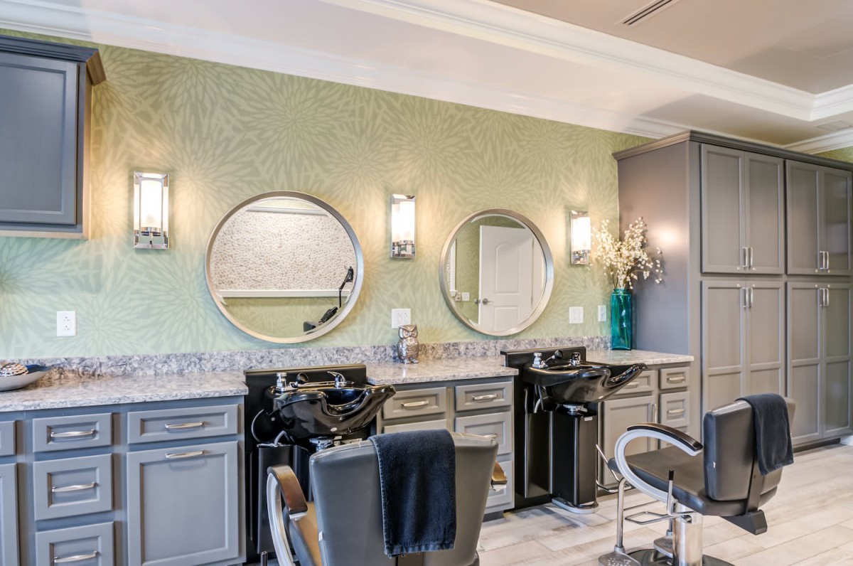 A modern hair salon with stylish mirrors and chairs, featuring contemporary interior design.