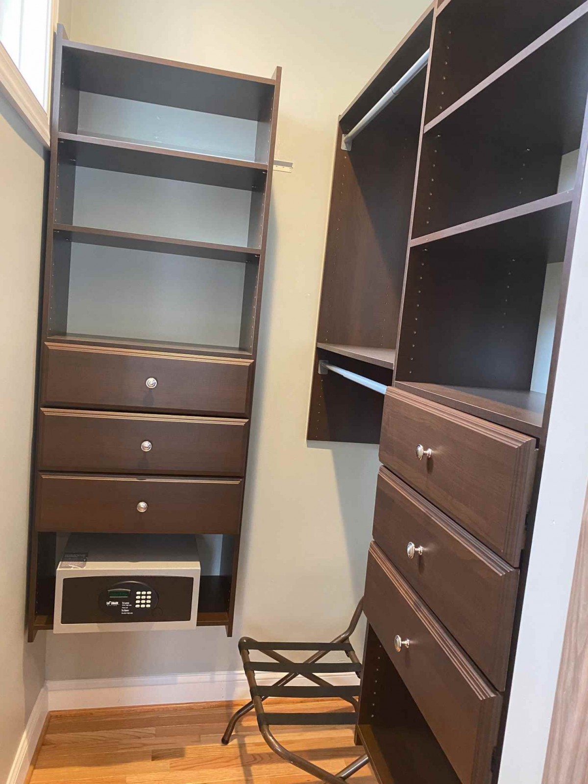 A well-organized closet with shelves, drawers, and a safe.