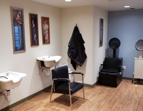 Interior of a hair salon with styling chairs and equipment.