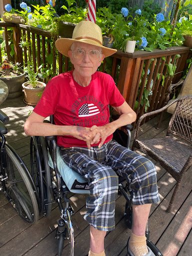 An individual comfortably seated in a wheelchair, enjoying the outdoors.