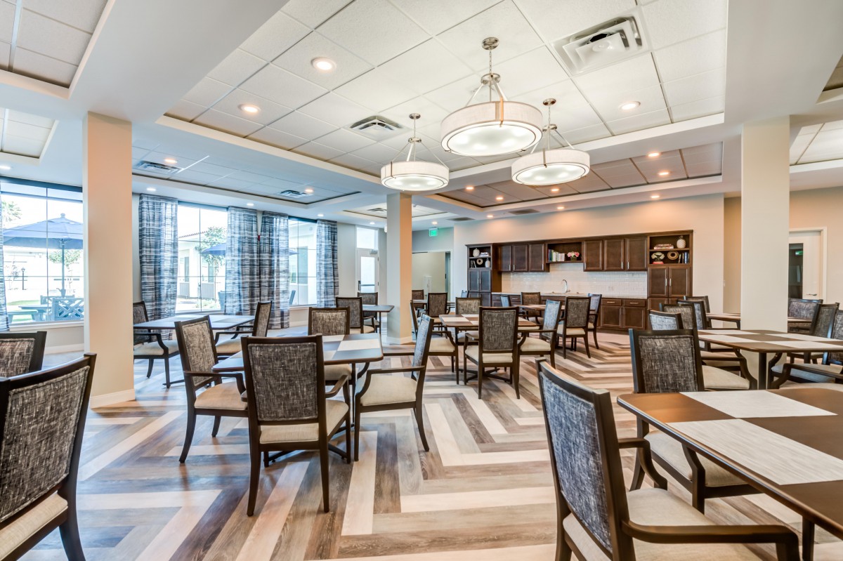 A modern dining room with elegant lighting and stylish furniture.