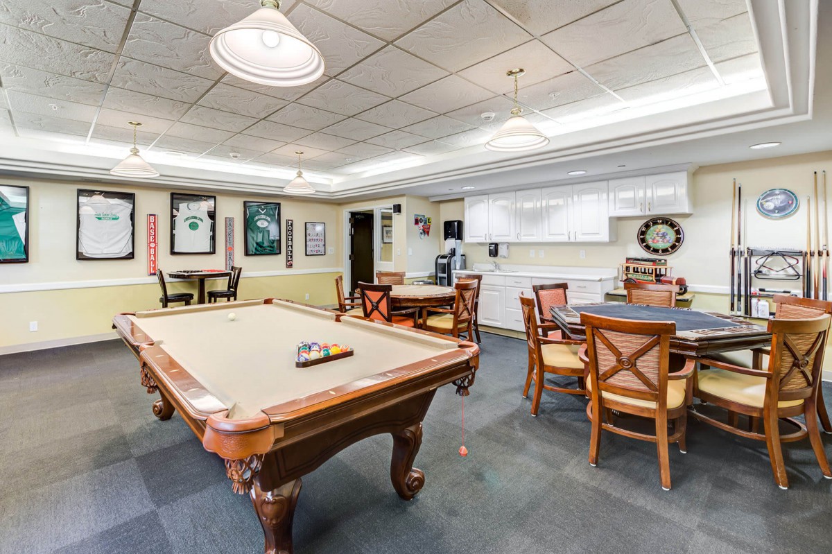 A cozy game room featuring a pool table and seating area, ideal for recreation and leisure activities.