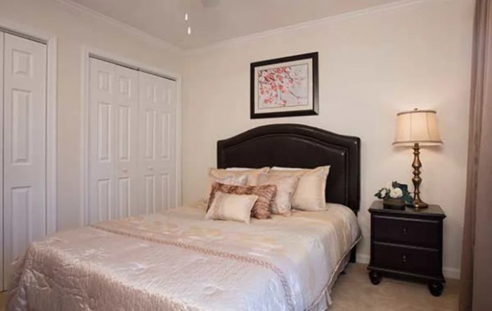 A cozy bedroom with elegant decor and a comfortable bed.