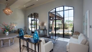 A modern living room with large windows and stylish decor.
