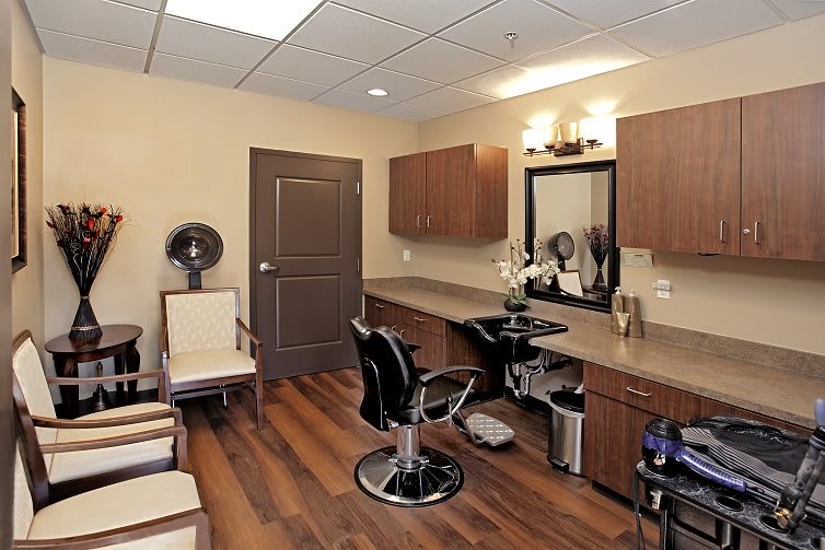 A modern hair salon interior with styling chairs and a large mirror.
