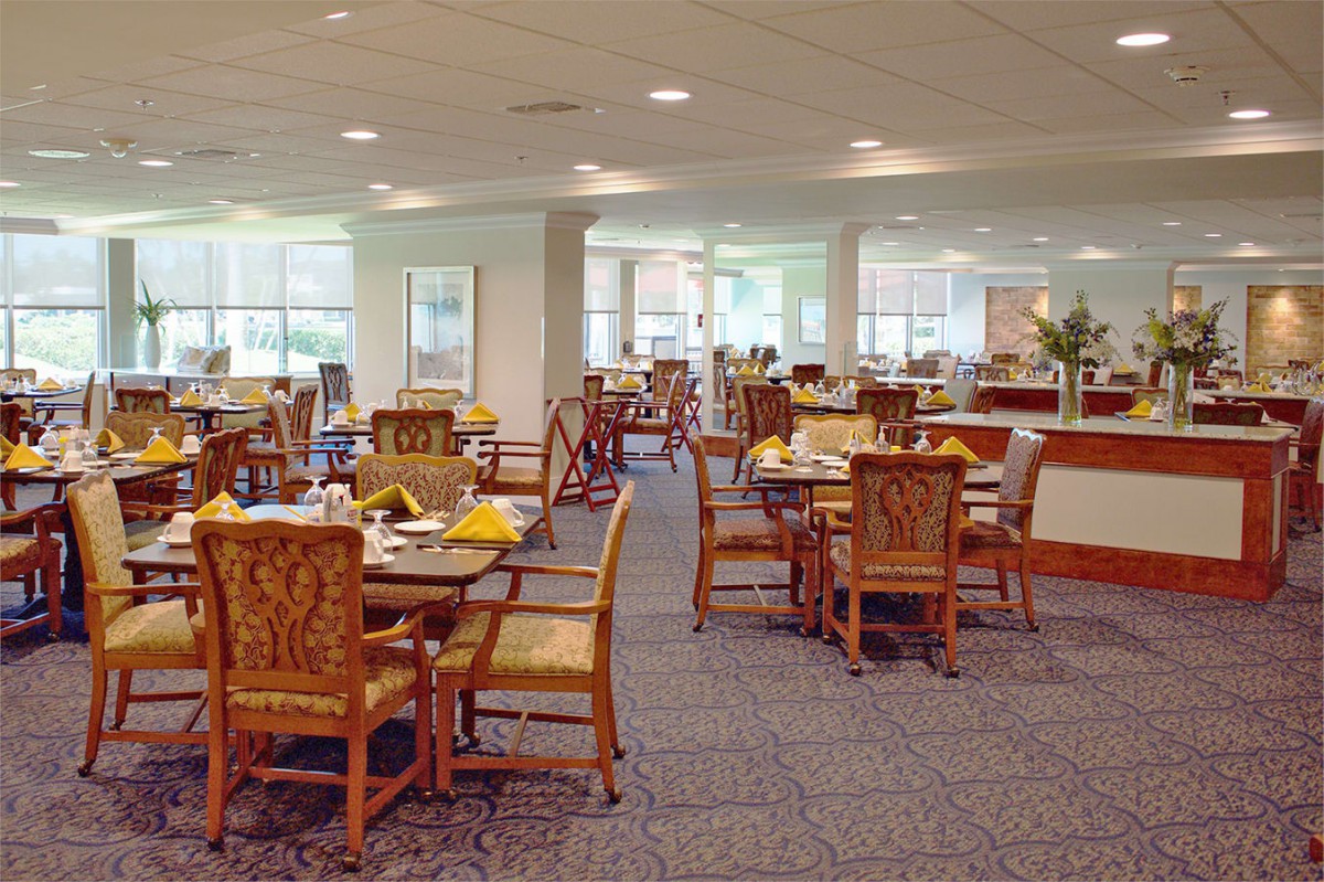 An empty dining area with neatly arranged tables and chairs.