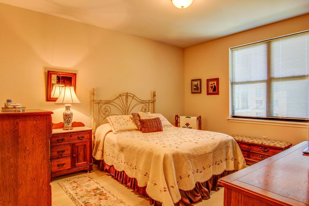 A cozy bedroom with vintage decor and warm lighting.