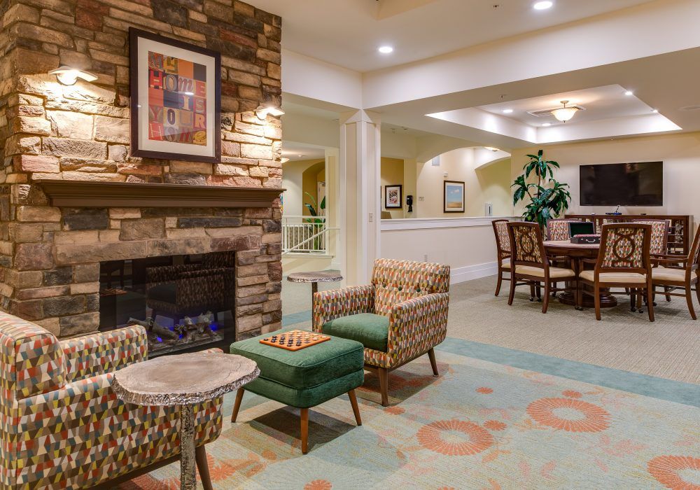 A cozy living room with a fireplace, comfortable seating, and warm interior design.