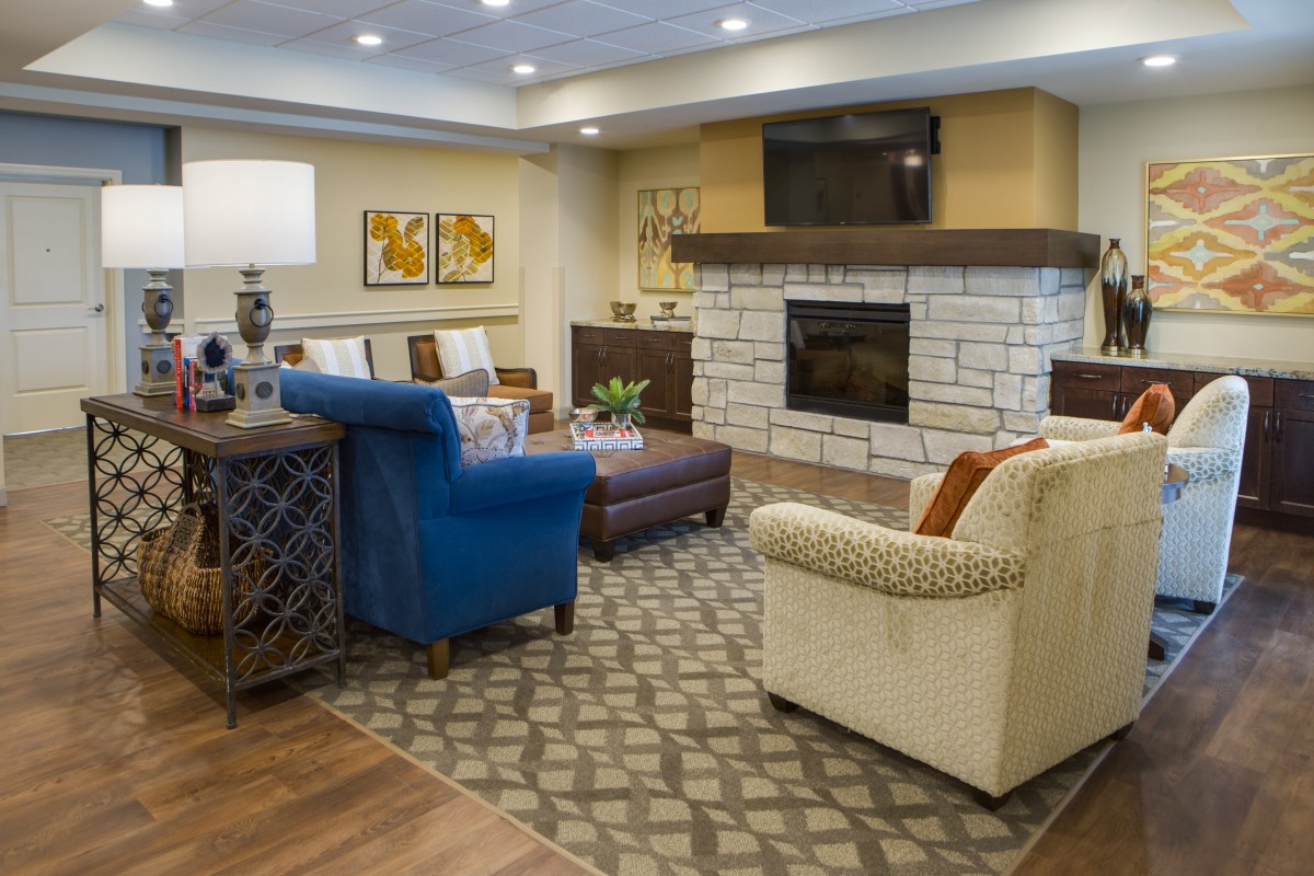 A cozy living room with comfortable seating, a fireplace, and modern decor.