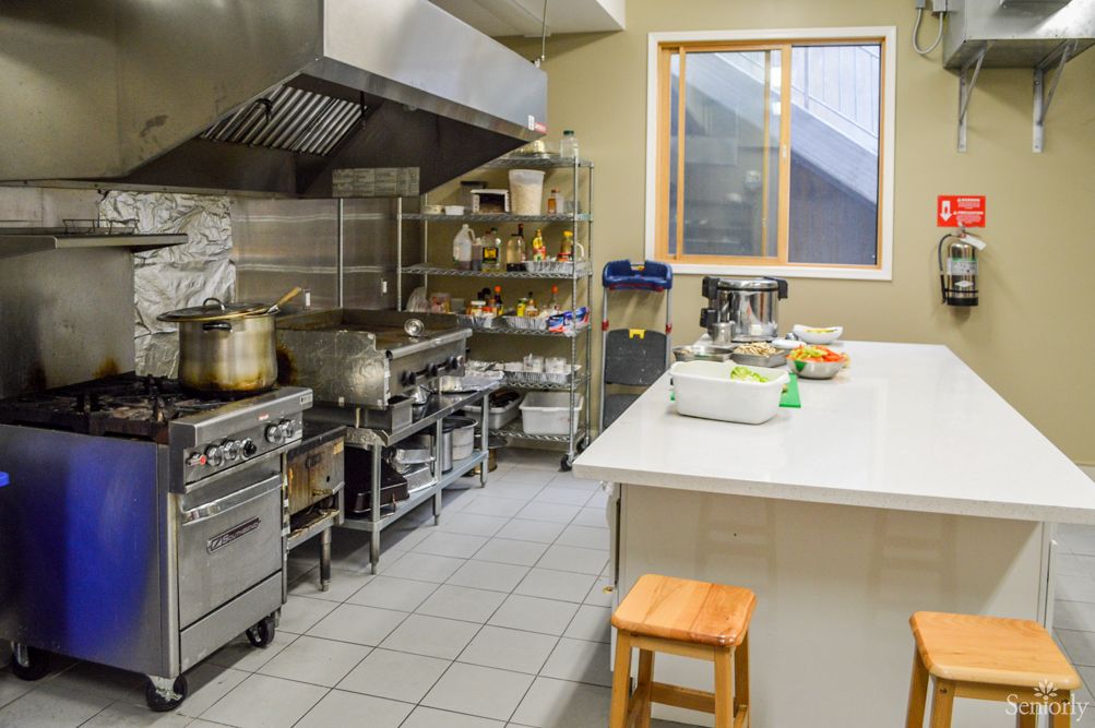 A well-equipped commercial kitchen featuring stainless steel appliances and an industrial stove.