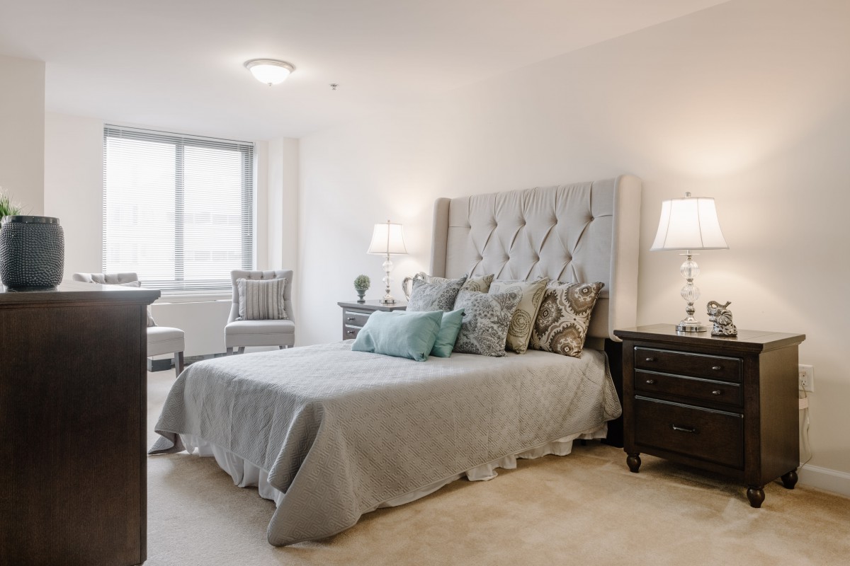 A modern bedroom with elegant decor and natural lighting.