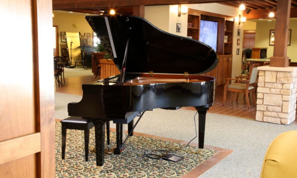 A grand piano sits elegantly in a cozy music room.