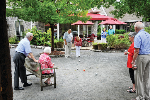 Seniors enjoying a friendly game of bocce ball in a community park.