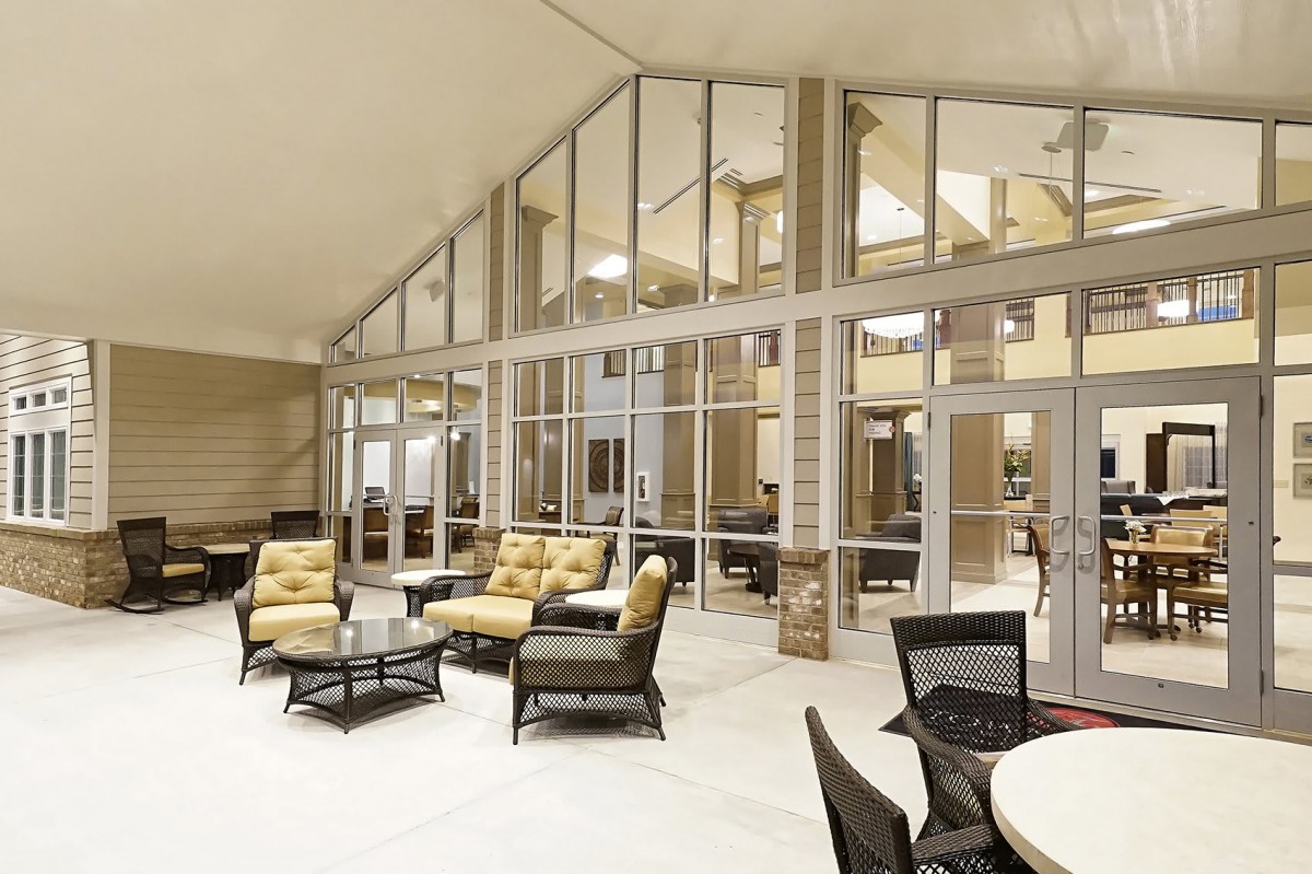 A modern lounge area with comfortable seating and glass walls.