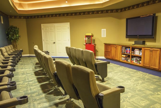 A cozy home theater with comfortable seating and a large screen.