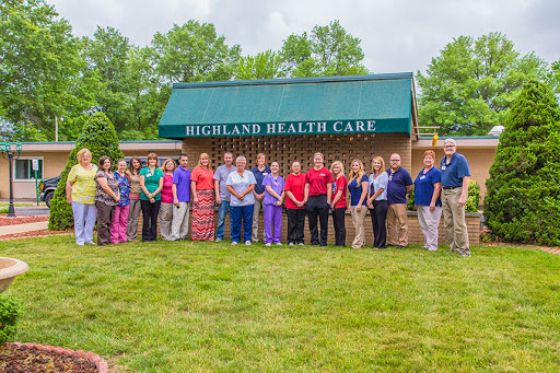 A dedicated healthcare team gathered outside Highland Health Care, showcasing their commitment to community health.