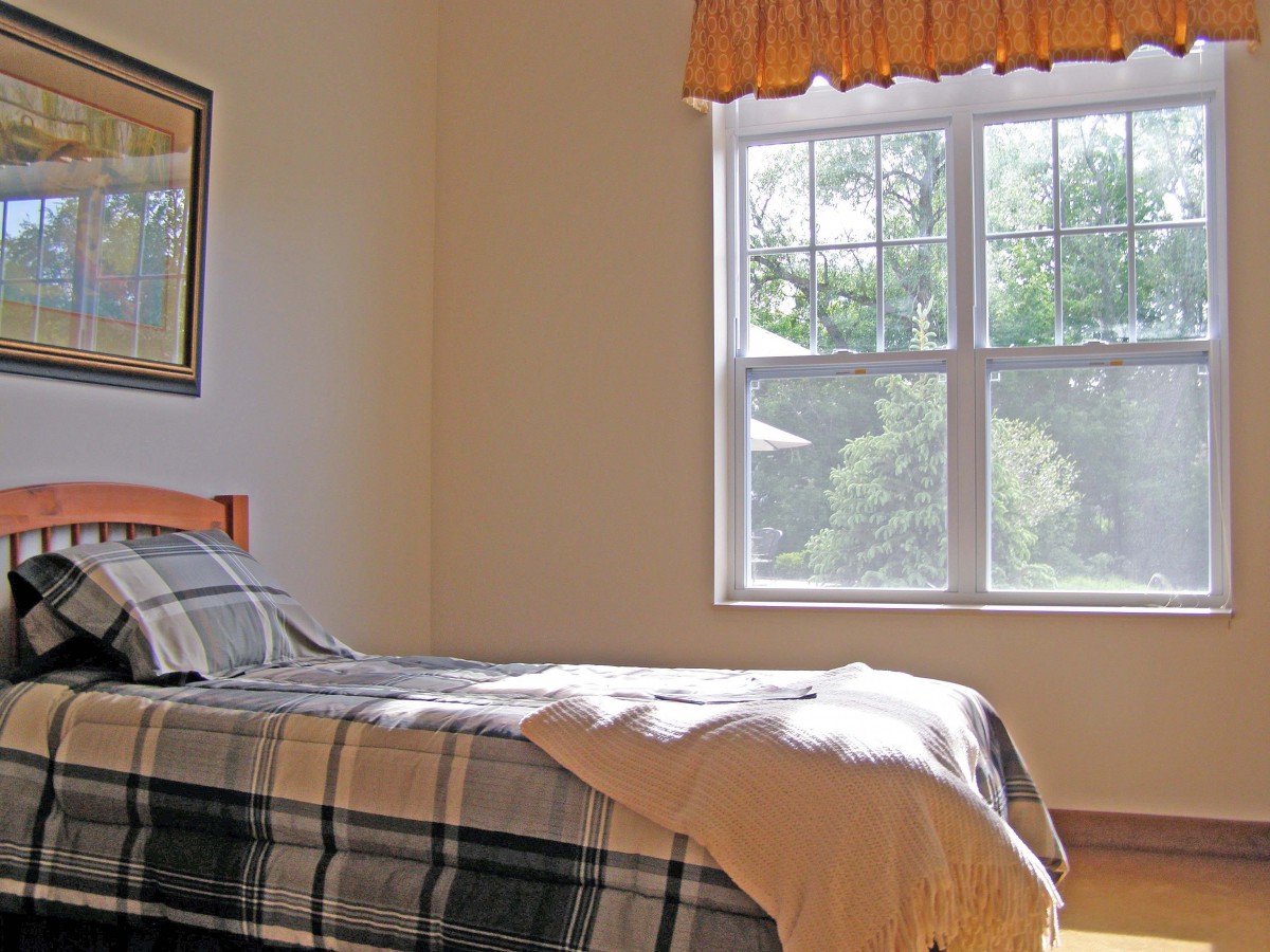 A cozy bedroom with sunlight filtering through the window.