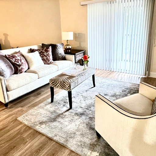 A cozy and stylish living room featuring a comfortable sofa, elegant chairs, and tasteful decor.
