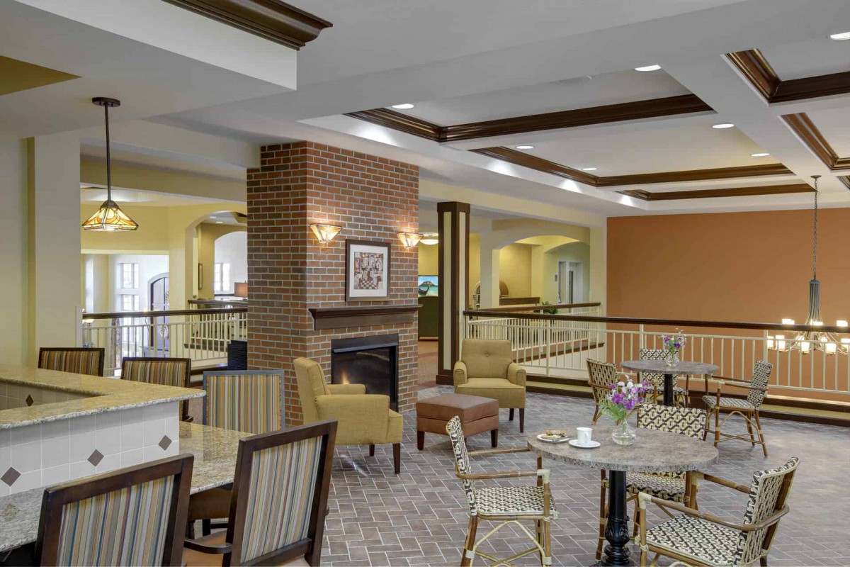 A cozy lounge area with comfortable seating and a fireplace.
