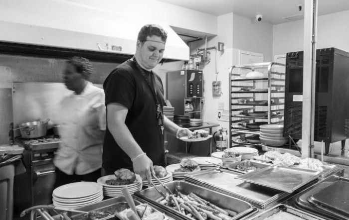 Chefs busy at work in a bustling kitchen.