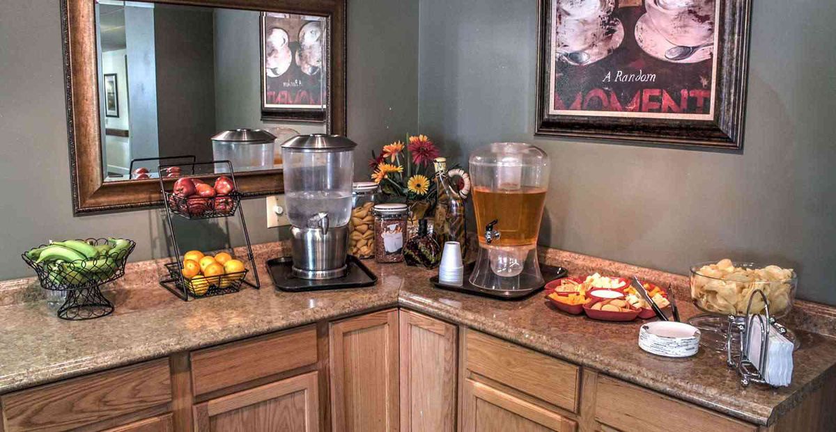A cozy buffet corner with beverages and snacks on display.