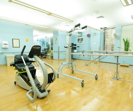 A spacious rehabilitation gym featuring exercise equipment for physical therapy.