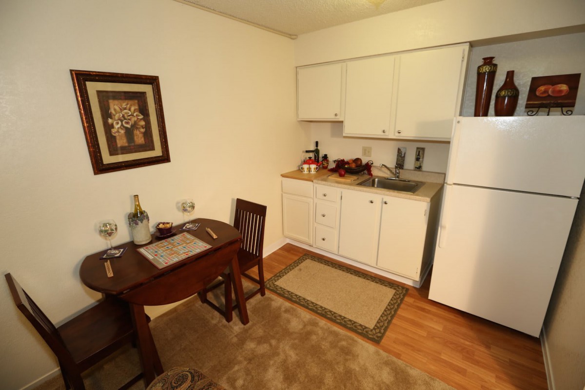 A cozy kitchen and dining area with a small table set for two.