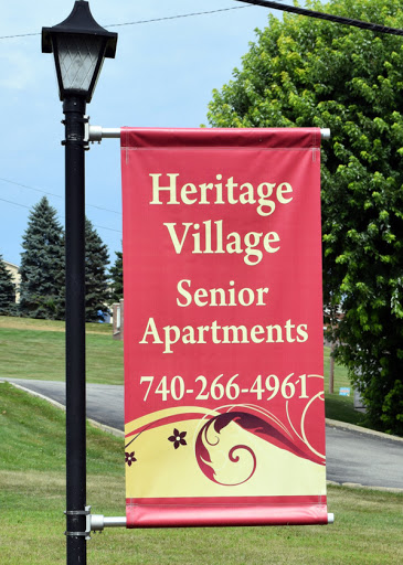 A banner displaying information about Heritage Village Senior Apartments.