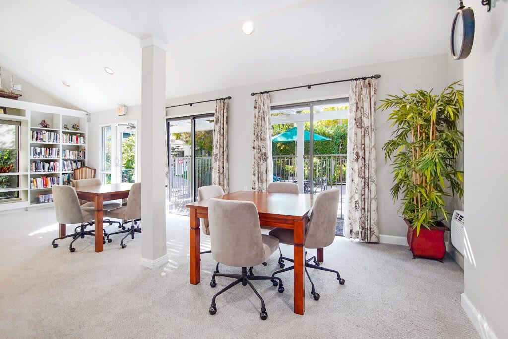 A modern office space with large windows, natural light, and contemporary furniture.