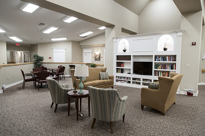 A cozy living room with comfortable seating and a built-in bookshelf, perfect for relaxation.